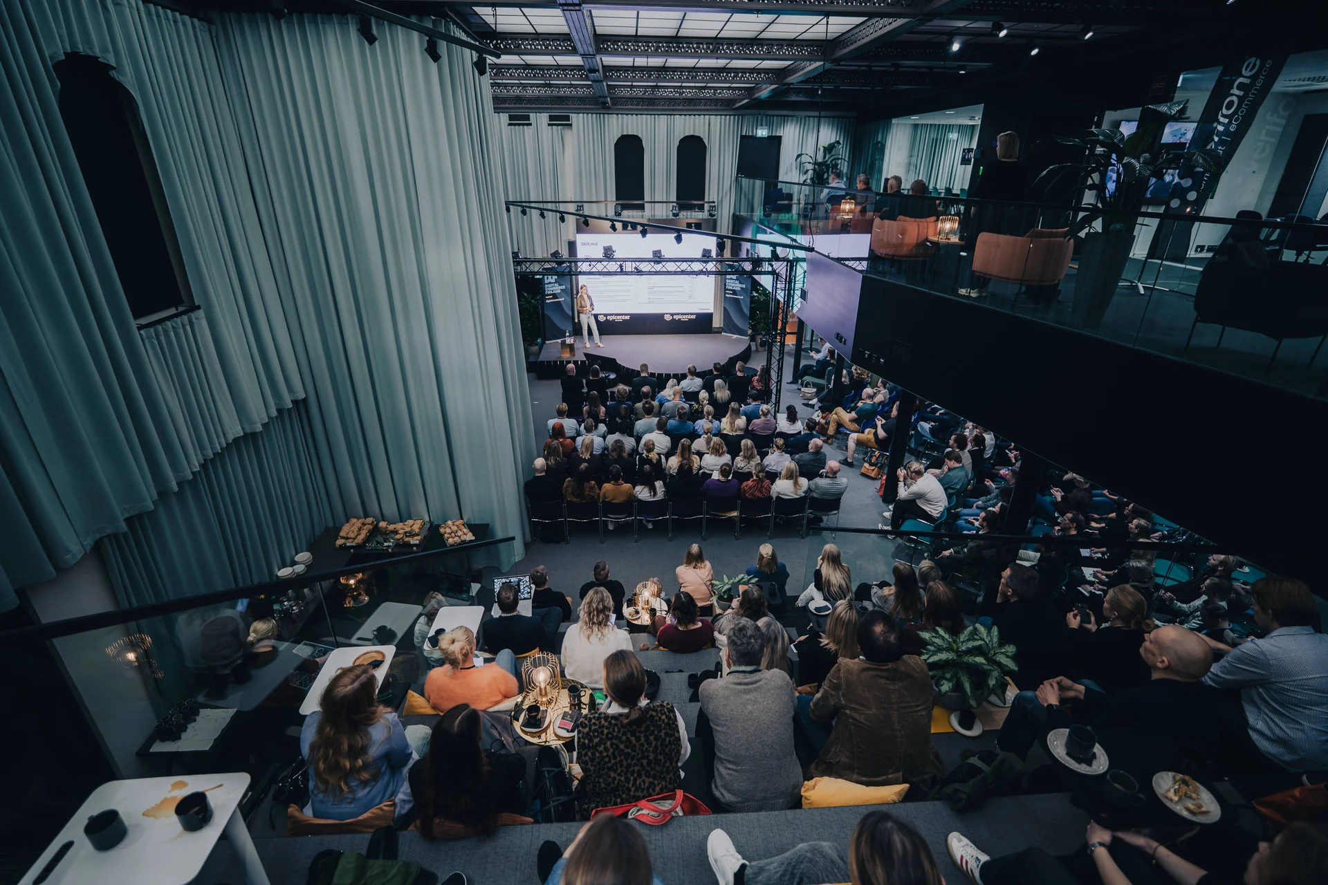 An audience listening to Kristiina Åberg speak at a Digital Commerce Finland event.